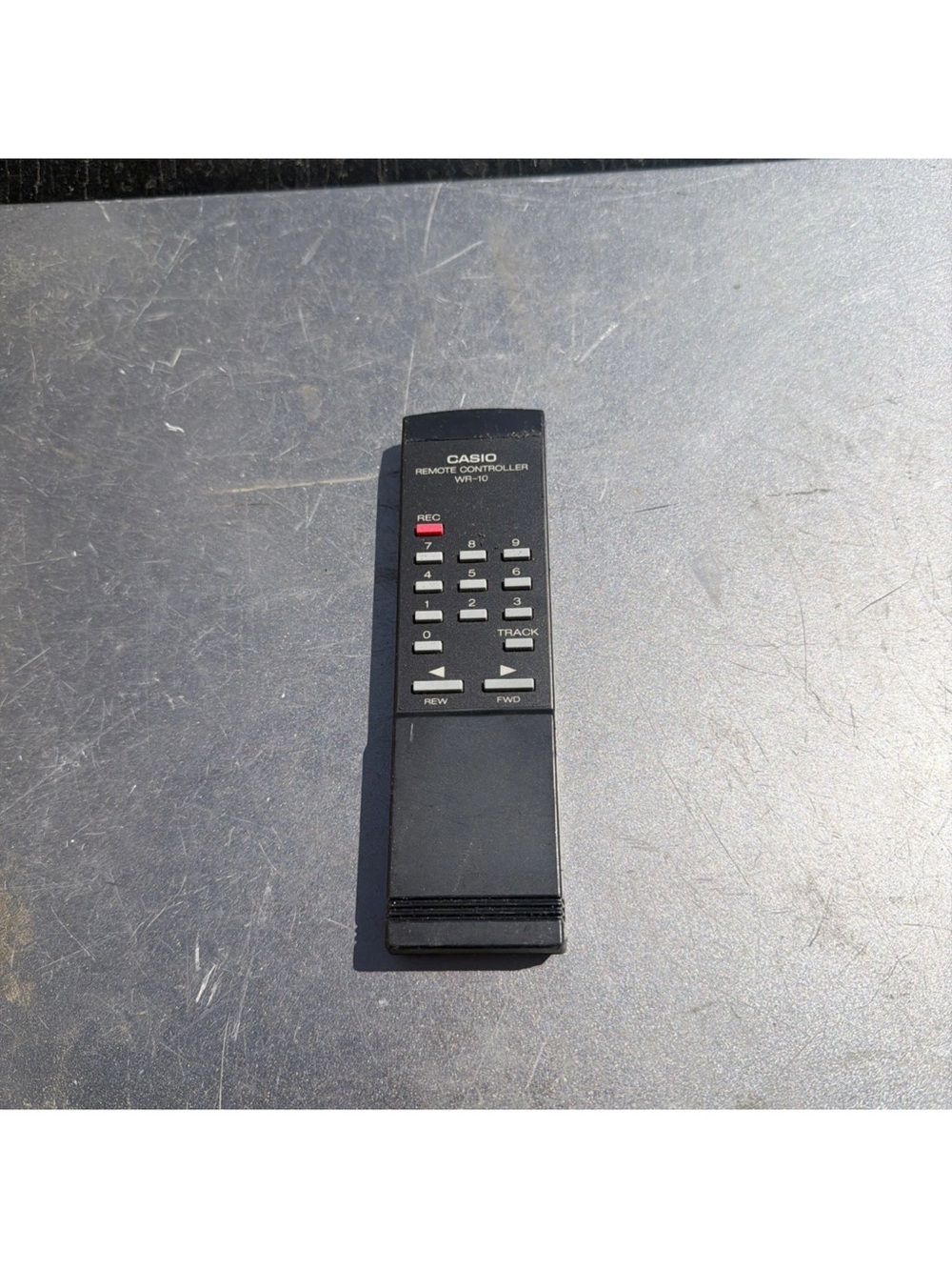Casio Black Remote Controller with White and Red Buttons